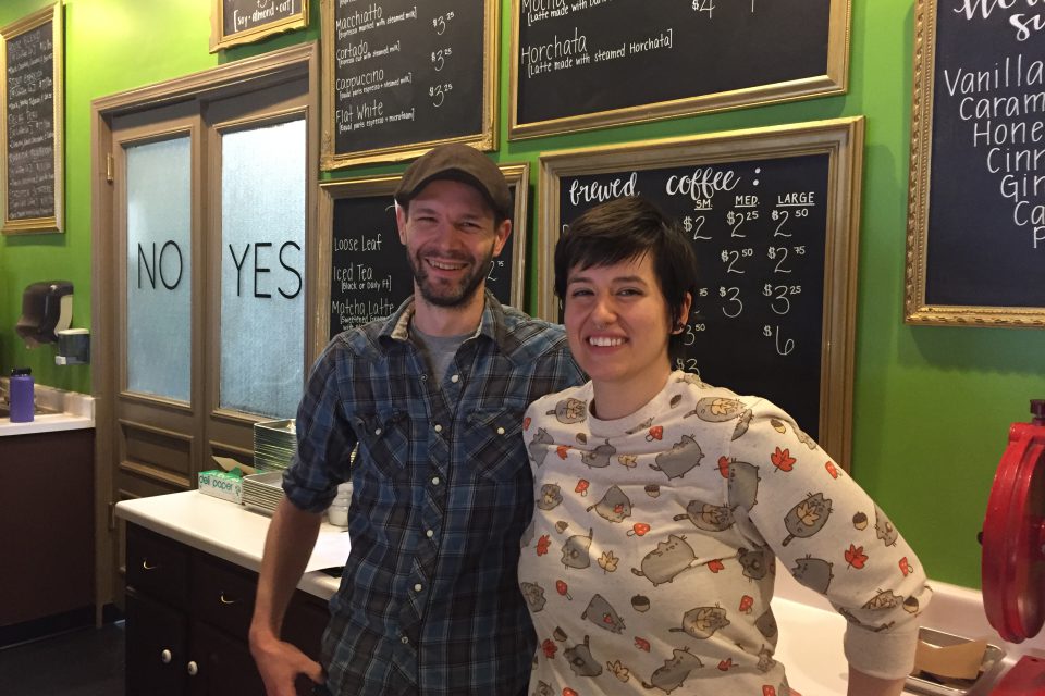 Tommy and Amber standing behind their cafe counter