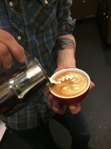 Tommy creating design in latte