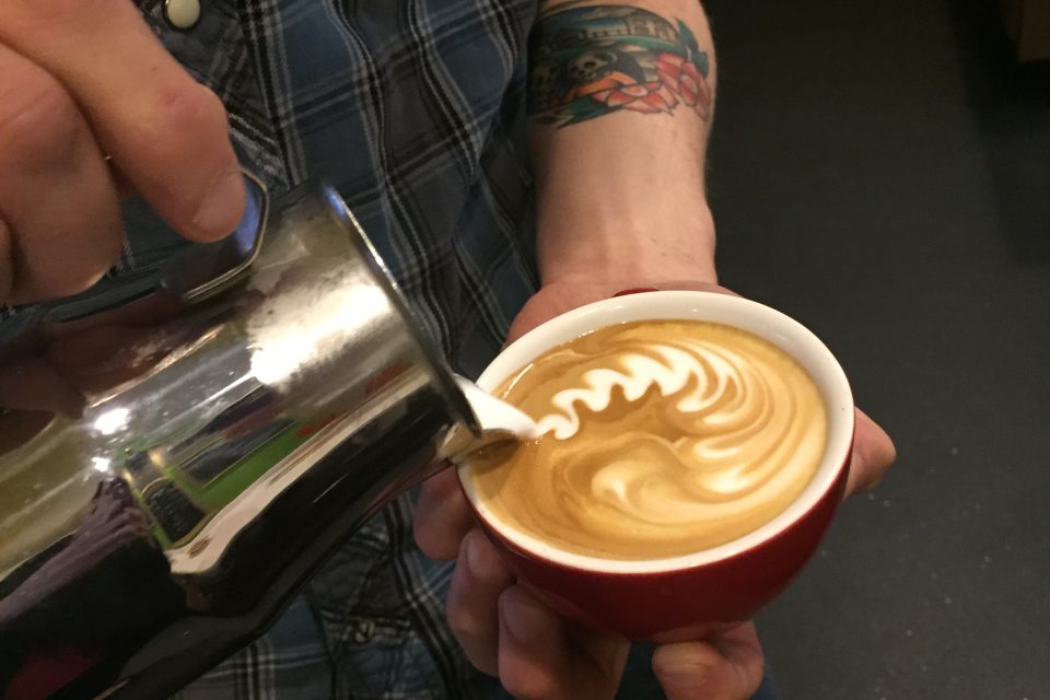Tommy creating design in latte
